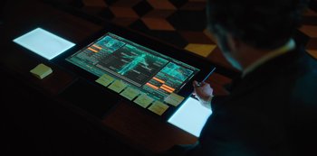 Movie still from “Altered Carbon” (2018), created by Laeta Kalogridis – A man using a tablet computer in front of a computer screen; Extreme Close Up shot, Over the shoulder angle