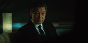 Movie still from “Altered Carbon” (2018), created by Laeta Kalogridis – An older man in a suit and tie; Close Up shot, Low angle
