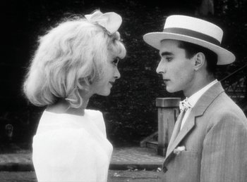 Movie still from “The Fiancés of the Bridge Mac Donald” (1961), directed by Agnès Varda – A man and a woman standing next to each other; Close Up shot, Over the shoulder angle
