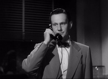 Movie still from “The File on Thelma Jordon” (1949), directed by Robert Siodmak – A black and white photo of a man talking on a phone; Close Up shot, Low angle