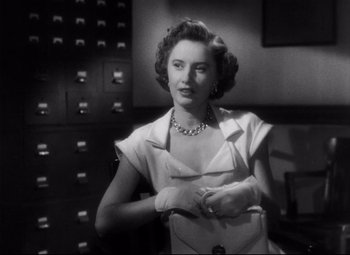 Movie still from “The File on Thelma Jordon” (1949), directed by Robert Siodmak – An old photo of a woman in a white dress; Close Up shot, Low angle