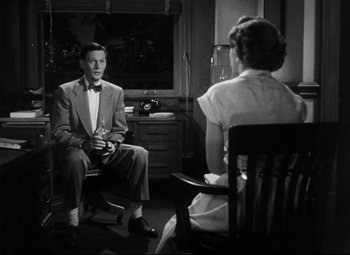 Movie still from “The File on Thelma Jordon” (1949), directed by Robert Siodmak – A man and a woman sitting in front of each other in a room; Medium shot, Low angle