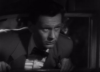 Movie still from “The File on Thelma Jordon” (1949), directed by Robert Siodmak – A man wearing a suit and bow tie; Close Up shot, High angle