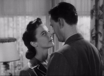 Movie still from “The File on Thelma Jordon” (1949), directed by Robert Siodmak – A man and a woman kissing in front of a window; Close Up shot, Low angle