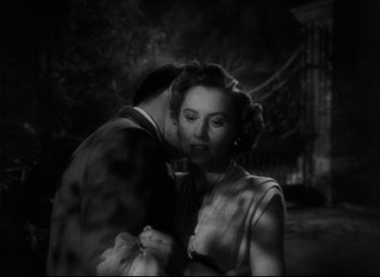 Movie still from “The File on Thelma Jordon” (1949), directed by Robert Siodmak – A man and a woman kissing in front of a bridge; Close Up shot, Over the shoulder angle