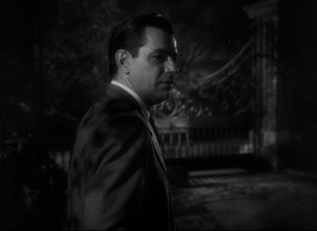 Movie still from “The File on Thelma Jordon” (1949), directed by Robert Siodmak – A black and white photo of a man in a suit and tie; Close Up shot, Over the shoulder angle