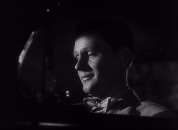 Movie still from “The File on Thelma Jordon” (1949), directed by Robert Siodmak – A black and white photo of a man in a bow tie; Close Up shot, Low angle