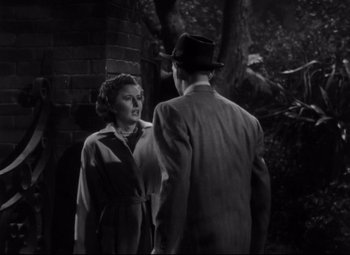 Movie still from “The File on Thelma Jordon” (1949), directed by Robert Siodmak – A man and a woman standing next to each other in front of a brick wall; Medium shot, Over the shoulder angle