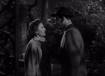 Movie still from “The File on Thelma Jordon” (1949), directed by Robert Siodmak – A man and a woman standing next to each other in front of trees; Medium shot, Over the shoulder angle