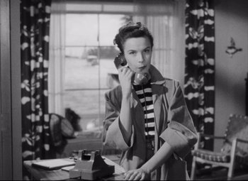 Movie still from “The File on Thelma Jordon” (1949), directed by Robert Siodmak – A black and white photo of a woman talking on a phone; Medium shot, High angle