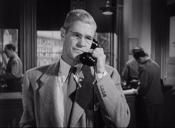 Movie still from “The File on Thelma Jordon” (1949), directed by Robert Siodmak – An older man wearing a suit and tie while talking on a phone; Close Up shot, Low angle