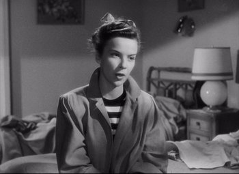 Movie still from “The File on Thelma Jordon” (1949), directed by Robert Siodmak – A black - and - white photo of a woman in a trench coat; Close Up shot, High angle