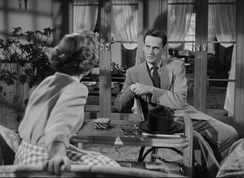 Movie still from “The File on Thelma Jordon” (1949), directed by Robert Siodmak – A man and a woman sitting at a table; Medium shot, Over the shoulder angle