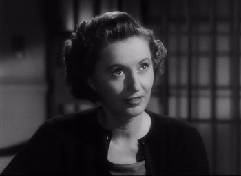 Movie still from “The File on Thelma Jordon” (1949), directed by Robert Siodmak – An old photo of an older woman in a black sweater; Close Up shot, High angle