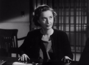 Movie still from “The File on Thelma Jordon” (1949), directed by Robert Siodmak – An older woman sitting at a table in front of a cell phone; Close Up shot, Low angle