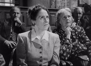 Movie still from “The File on Thelma Jordon” (1949), directed by Robert Siodmak – Two women and a man are sitting in a courtroom; Medium shot, Low angle