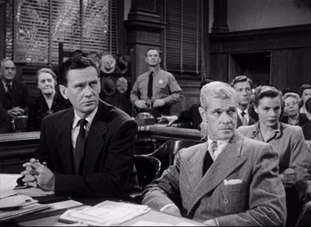 Movie still from “The File on Thelma Jordon” (1949), directed by Robert Siodmak – A group of men sitting in a courtroom; Medium shot, Over the shoulder angle