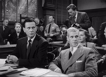 Movie still from “The File on Thelma Jordon” (1949), directed by Robert Siodmak – A group of men sitting at a table in front of a camera; Medium shot, Low angle