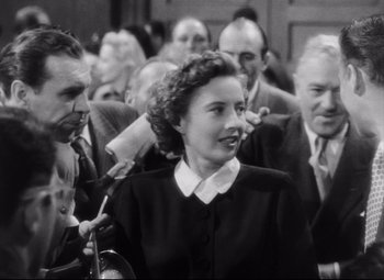 Movie still from “The File on Thelma Jordon” (1949), directed by Robert Siodmak – An old photo of a woman in a crowd of people; Medium shot, High angle