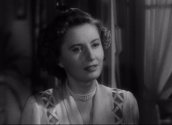 Movie still from “The File on Thelma Jordon” (1949), directed by Robert Siodmak – An old photo of a woman in a dress; Close Up shot, Over the shoulder angle