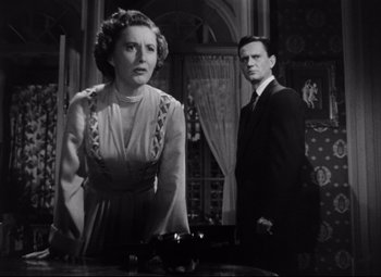 Movie still from “The File on Thelma Jordon” (1949), directed by Robert Siodmak – A man and a woman standing next to each other in a room; Medium shot, Low angle