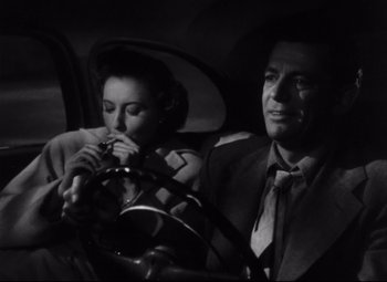 Movie still from “The File on Thelma Jordon” (1949), directed by Robert Siodmak – A man and a woman sitting in the back seat of a car; Medium shot, Low angle