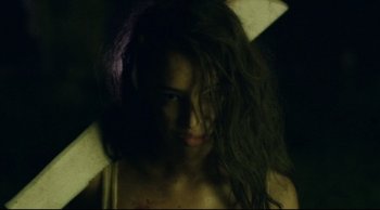 Movie still from “The Final Girls” (2015), directed by Todd Strauss-Schulson – A woman with long dark brown hair and a white shirt; Close Up shot, Over the shoulder angle