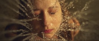 Movie still from “The Final Girls” (2015), directed by Todd Strauss-Schulson – A woman with her eyes closed in front of a glass wall; Extreme Close Up shot, Overhead angle