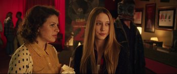 Movie still from “The Final Girls” (2015), directed by Todd Strauss-Schulson – A woman sitting next to another woman in front of a camera; Close Up shot, Over the shoulder angle