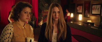 Movie still from “The Final Girls” (2015), directed by Todd Strauss-Schulson – A woman with long blonde hair standing next to a man; Close Up shot, Over the shoulder angle