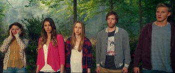 Movie still from “The Final Girls” (2015), directed by Todd Strauss-Schulson – A group of people standing next to each other in the woods; Medium shot, Over the shoulder angle