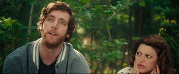 Movie still from “The Final Girls” (2015), directed by Todd Strauss-Schulson – A man with a beard is sitting in the woods; Close Up shot, Over the shoulder angle