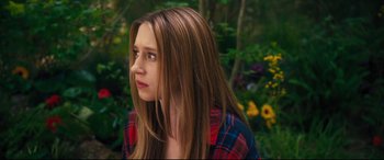 Movie still from “The Final Girls” (2015), directed by Todd Strauss-Schulson – A woman with long hair wearing a red and blue plaid shirt; Close Up shot, Over the shoulder angle