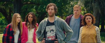 Movie still from “The Final Girls” (2015), directed by Todd Strauss-Schulson – A man standing in front of two other people; Medium shot, Low angle