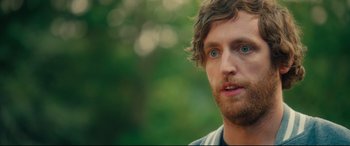 Movie still from “The Final Girls” (2015), directed by Todd Strauss-Schulson – A person with a beard and blue eyes; Close Up shot, Over the shoulder angle