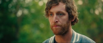 Movie still from “The Final Girls” (2015), directed by Todd Strauss-Schulson – A person with a beard and blue eyes; Close Up shot, Over the shoulder angle