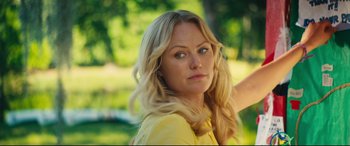 Movie still from “The Final Girls” (2015), directed by Todd Strauss-Schulson – A beautiful blonde woman with blue eyes in a yellow shirt; Close Up shot, Over the shoulder angle