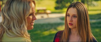 Movie still from “The Final Girls” (2015), directed by Todd Strauss-Schulson – Two women talking in a park with a picnic table in the background; Close Up shot, Over the shoulder angle