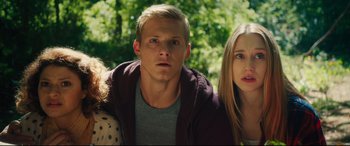 Movie still from “The Final Girls” (2015), directed by Todd Strauss-Schulson – A man and a woman standing next to each other in front of trees; Close Up shot, Low angle