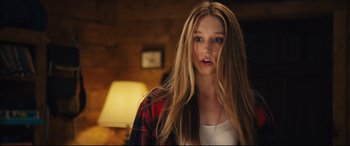 Movie still from “The Final Girls” (2015), directed by Todd Strauss-Schulson – A woman with long blonde hair wearing a red and black plaid shirt; Close Up shot, Over the shoulder angle
