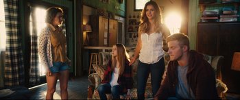 Movie still from “The Final Girls” (2015), directed by Todd Strauss-Schulson – A woman and a girl standing in a living room next to each other; Medium shot, Over the shoulder angle