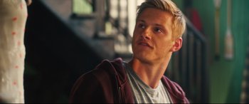 Movie still from “The Final Girls” (2015), directed by Todd Strauss-Schulson – A man with blonde hair and a gray shirt is looking up; Close Up shot, Over the shoulder angle