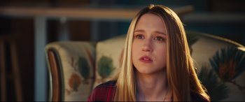 Movie still from “The Final Girls” (2015), directed by Todd Strauss-Schulson – A young woman with long blonde hair sitting on a couch; Close Up shot, Over the shoulder angle