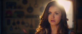 Movie still from “The Final Girls” (2015), directed by Todd Strauss-Schulson – A beautiful woman with long brown wavy hair; Close Up shot, Over the shoulder angle