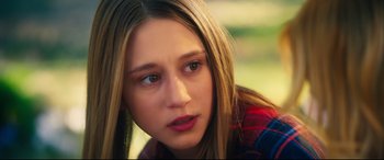 Movie still from “The Final Girls” (2015), directed by Todd Strauss-Schulson – A person sitting down with her eyes closed; Close Up shot, Over the shoulder angle