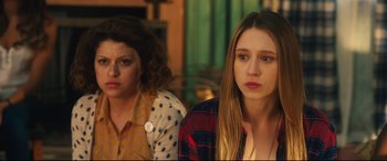 Movie still from “The Final Girls” (2015), directed by Todd Strauss-Schulson – Two young women sitting next to each other in a room; Close Up shot, Over the shoulder angle