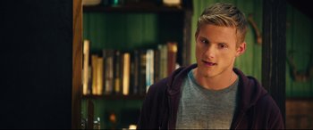 Movie still from “The Final Girls” (2015), directed by Todd Strauss-Schulson – A man standing in front of a book shelf; Close Up shot, Over the shoulder angle