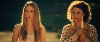 Movie still from “The Final Girls” (2015), directed by Todd Strauss-Schulson – Two women sitting on a bench in the sunlight; Close Up shot, Over the shoulder angle