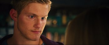 Movie still from “The Final Girls” (2015), directed by Todd Strauss-Schulson – A man's face in front of a blurry background; Close Up shot, Over the shoulder angle