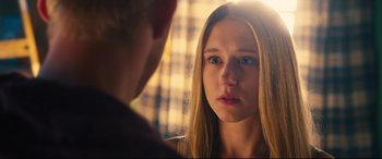 Movie still from “The Final Girls” (2015), directed by Todd Strauss-Schulson – A young woman looking at a man in a room; Close Up shot, Over the shoulder angle